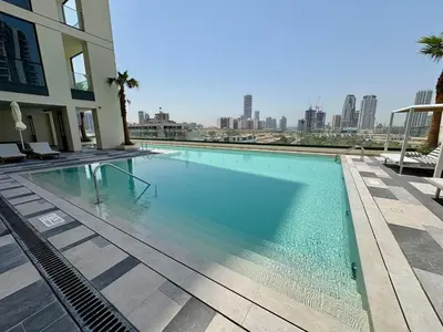 a large swimming pool with a view of the city at FIRST CLASS Studio Unwind in Style in Dubai