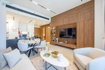 a living room with a couch and a table at Blue Breeze - Luxurious 1BR with Private Jacuzzi & Burj View in Dubai