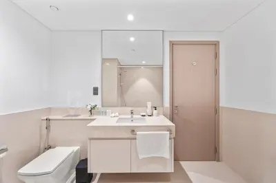 a white bathroom with a sink and a toilet at Act tower-1BR near Burj Khalifa in Dubai