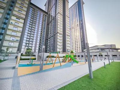 a playground in a city with tall buildings at EasyGo-Modern, Distinguished with Sofa Bed in Dubai