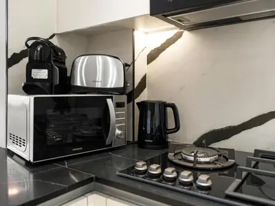 a microwave oven sitting on top of a kitchen counter at Exclusive 1BD with Burj View & Private Jacuzzi in Dubai