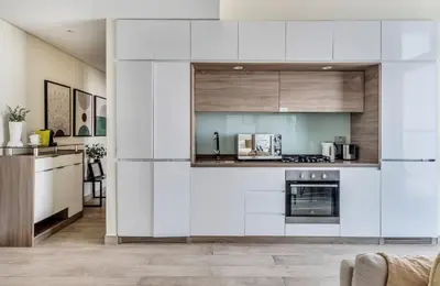 a kitchen with white cabinets and a stove at GuestReady - Luxe waterfront stay in Dubai Marina in Dubai