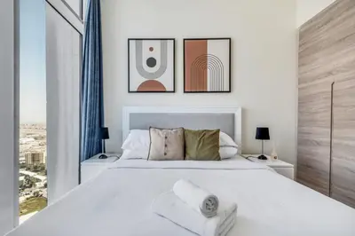 a bedroom with a large white bed with a window at GuestReady - Luxe waterfront stay in Dubai Marina in Dubai