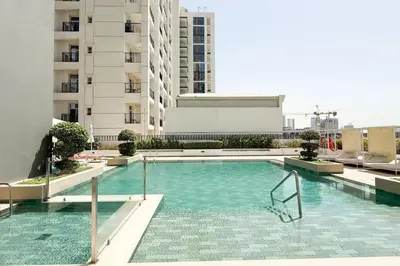 a swimming pool on the roof of a building at Restay Homes - Fancy 2BR in Belgravia Heights - Pool access in Dubai