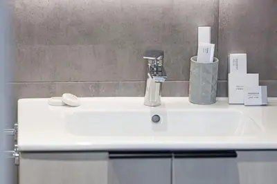a bathroom sink with a faucet on top of it at Restay Homes - Fancy 2BR in Belgravia Heights - Pool access in Dubai