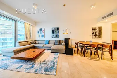a living room with a couch and a table at Trident Grand Residence 1 BDR plus Guest Bedroom, Dubai Marina in Dubai