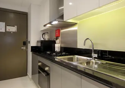 a kitchen with a sink and a stove at Sleek & Stylish Studio in DAMAC Prive, Dubai in Dubai
