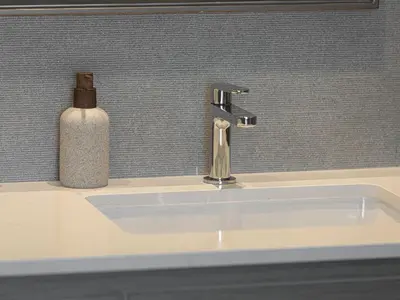 a bathroom sink with a soap dispenser on top of it at Grande Signature Residences by Prestige Nest in Dubai