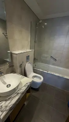 a bathroom with a sink and a toilet and a shower at Aykon city in Dubai