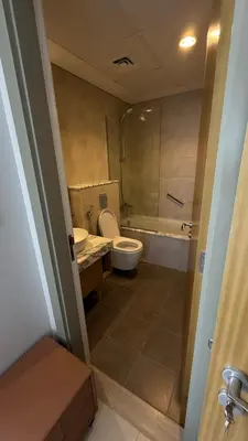 a bathroom with a toilet and a tub and a sink at Aykon city in Dubai