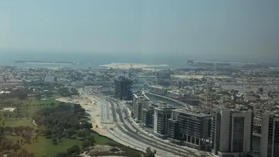 an aerial view of a city with a river and buildings at Aykon city in Dubai