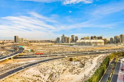 a view of a city with a highway and buildings at FIRST CLASS Studio Stylish Comfort in Dubai