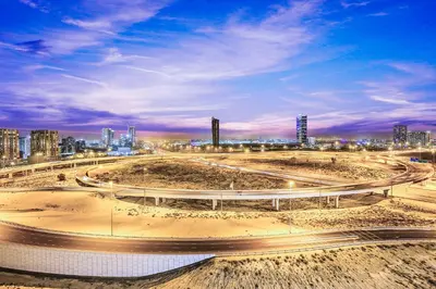 a freeway with a city in the background at FIRST CLASS Studio Stylish Comfort in Dubai