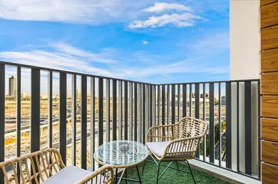 a balcony with two chairs and a table with a view at FIRST CLASS Studio Stylish Comfort in Dubai