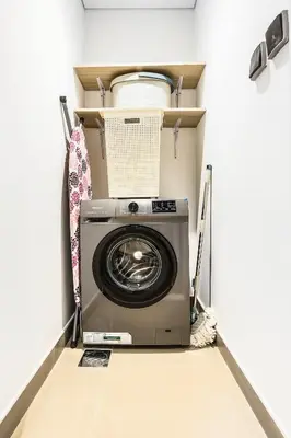 a washer and dryer in a room at FIRST CLASS Studio Stylish Comfort in Dubai