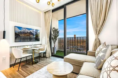 a living room with a couch and a table at FIRST CLASS Studio Stylish Comfort in Dubai