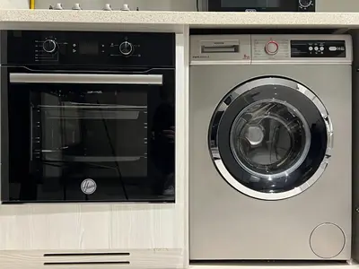 a washing machine and a dryer in a kitchen at KeyRock Living - 20th Floor Comfort at Zada in Dubai