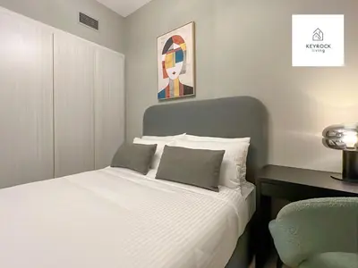 a white bed with two pillows in a bedroom at KeyRock Living - 20th Floor Comfort at Zada in Dubai