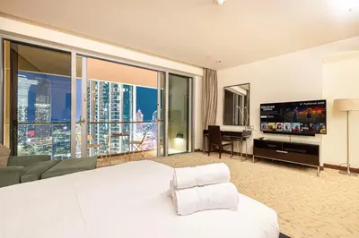 a hotel room with a large bed and a flat screen tv at Burj Khalifa View & Mall Entry in 3 Mins & Sleeps 3 Adults in Dubai