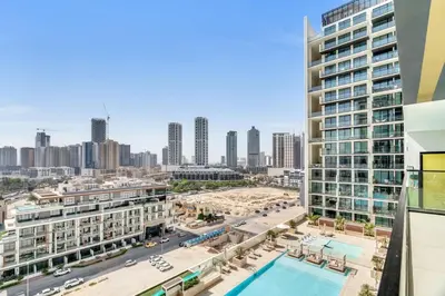 a view of the city from the balcony of a building at GuestReady - Jumeirah Village haven with pool view in Dubai
