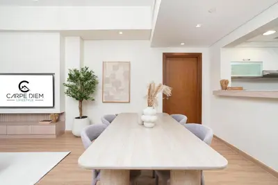 a dining room with a table and chairs at Marina Residence 6 - Luxurious Two Bedroom and Maid's - Lake and Sea View in Dubai