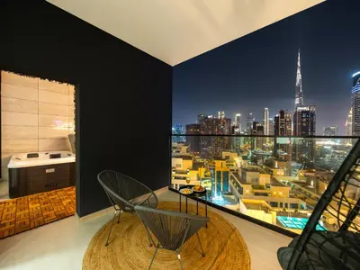 a dining room with a view of the city at Trendy 1BR Private Jacuzzi Burj Khalifa View in Dubai