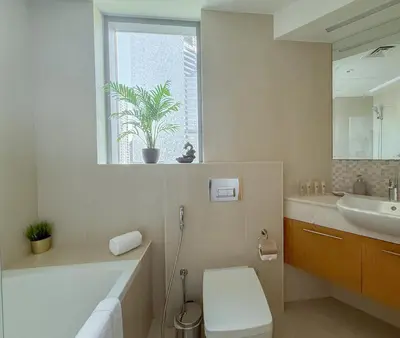a bathroom with a tub and a toilet and a sink at Burj Khalifa Panoramic view-1BR,4 guests, Downtown in Dubai