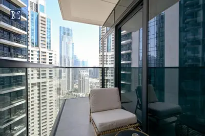 a balcony with a chair and a view of a city at Stylish Downtown Dubai Stay Act 1 Act 2 Tower 1 in Dubai