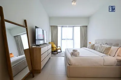 a white room with a bed and a television at Stylish Downtown Dubai Stay Act 1 Act 2 Tower 1 in Dubai