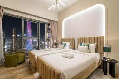 a bedroom with two beds and a large window at Gogoto3 High Floor Burj Khalifa NYE Fireworks View PS5 in Dubai