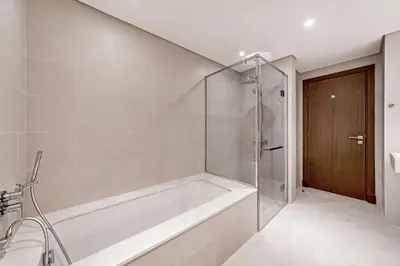 a bathroom with a tub and a glass shower at Luxury 2BR Apartment Burj Khalifa View in Al Safa in Dubai