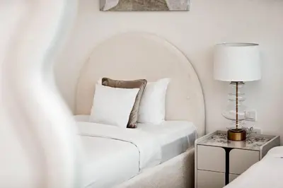 a white room with a chair and a lamp at Luxury 2BR Apartment Burj Khalifa View in Al Safa in Dubai