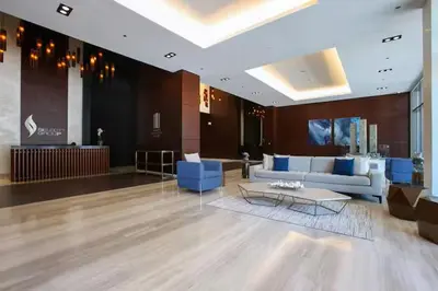 a lobby with a couch and a table in a building at Vogue Marina Gate near JBR Beach and Marina Mall, One Bedroom Apartment with Balcony and city skyline view, Access to all Amenities in Dubai