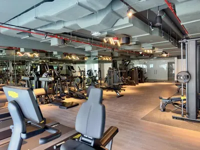 a gym with lots of treadmills and exercise equipment at Contemporary Urban 2BR Apartment in Dubai