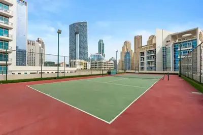 a tennis court in the middle of a city at Stunning Newly Furnished Elegant LUX Apartment in Dubai
