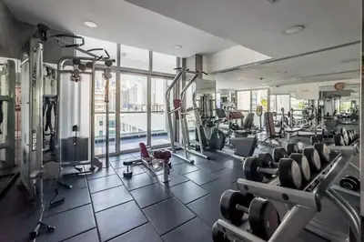 a gym with lots of treadmills and machines at Stunning Newly Furnished Elegant LUX Apartment in Dubai