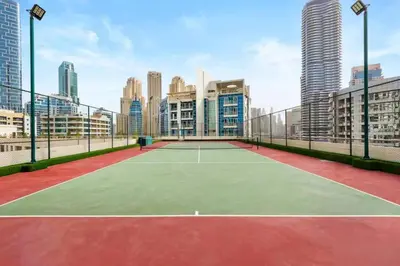a tennis court in the middle of a city at Stunning Newly Furnished Elegant LUX Apartment in Dubai