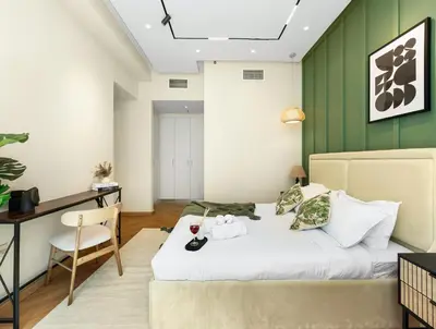 a bedroom with a bed and a desk and a table and chair at Stunning Newly Furnished Elegant LUX Apartment in Dubai