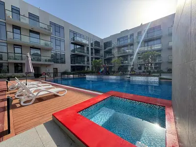 a swimming pool in front of a building at Spacious Designer Home Pool, Gym & Playground in Dubai