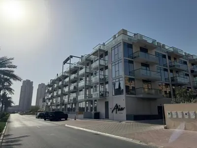 a large apartment building on the side of a street at Spacious Designer Home Pool, Gym & Playground in Dubai