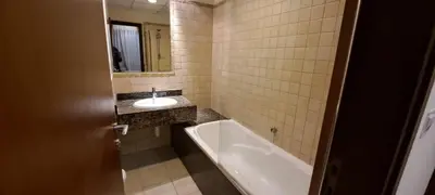 a bathroom with a bath tub and a sink at Zaman Vacation Homes in Dubai