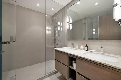 a bathroom with a shower and a sink and a mirror at 2BR Burj & Fountain View 5 mins to Dubai Mall in Dubai