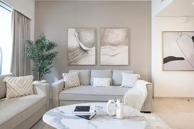 a living room with a couch and a table at 2BR Burj & Fountain View 5 mins to Dubai Mall in Dubai