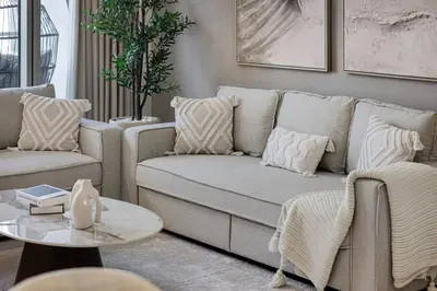 a living room with a couch and a table at 2BR Burj & Fountain View 5 mins to Dubai Mall in Dubai