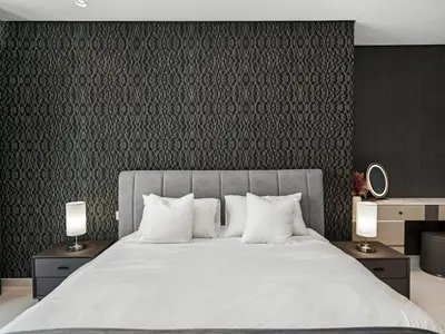 a bedroom with a large bed with white pillows at Spectacular Burj View from Infinity Pool in Dubai