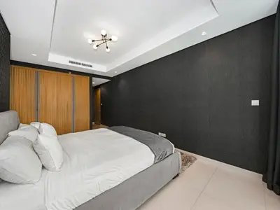 a bedroom with a white bed and a black wall at Spectacular Burj View from Infinity Pool in Dubai