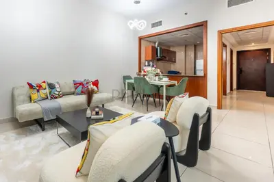 a living room with a couch and chairs and a table at Walk to Metro, Tram & Beach, Stylish 1BR in Marina Pinnacle, Dubai Marina by Deluxe Holiday Homes in Dubai