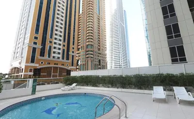 a swimming pool in a city with tall buildings at Walk to Metro, Tram & Beach, Stylish 1BR in Marina Pinnacle, Dubai Marina by Deluxe Holiday Homes in Dubai