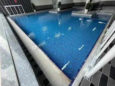 an overhead view of a swimming pool in a building at Walk to Metro, Tram & Beach, Stylish 1BR in Marina Pinnacle, Dubai Marina by Deluxe Holiday Homes in Dubai