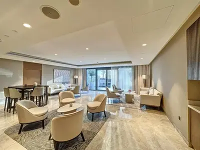 a lobby of a hotel with chairs and tables at Vogue Downtown Act One near Burj Khalifa and Dubai Mall, Two Bedroom Apartment with Balcony and City Skyline View, Access to All Amenities in Dubai